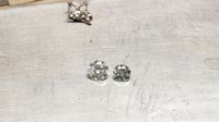 2 cts moissanite and 1 ct diamond on workbench